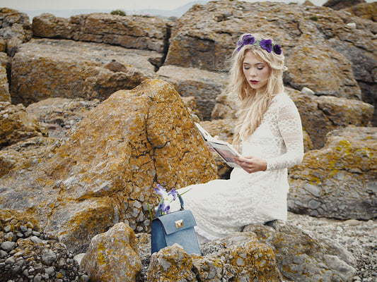 Model reading shakespeare with a Moray Luke bag
